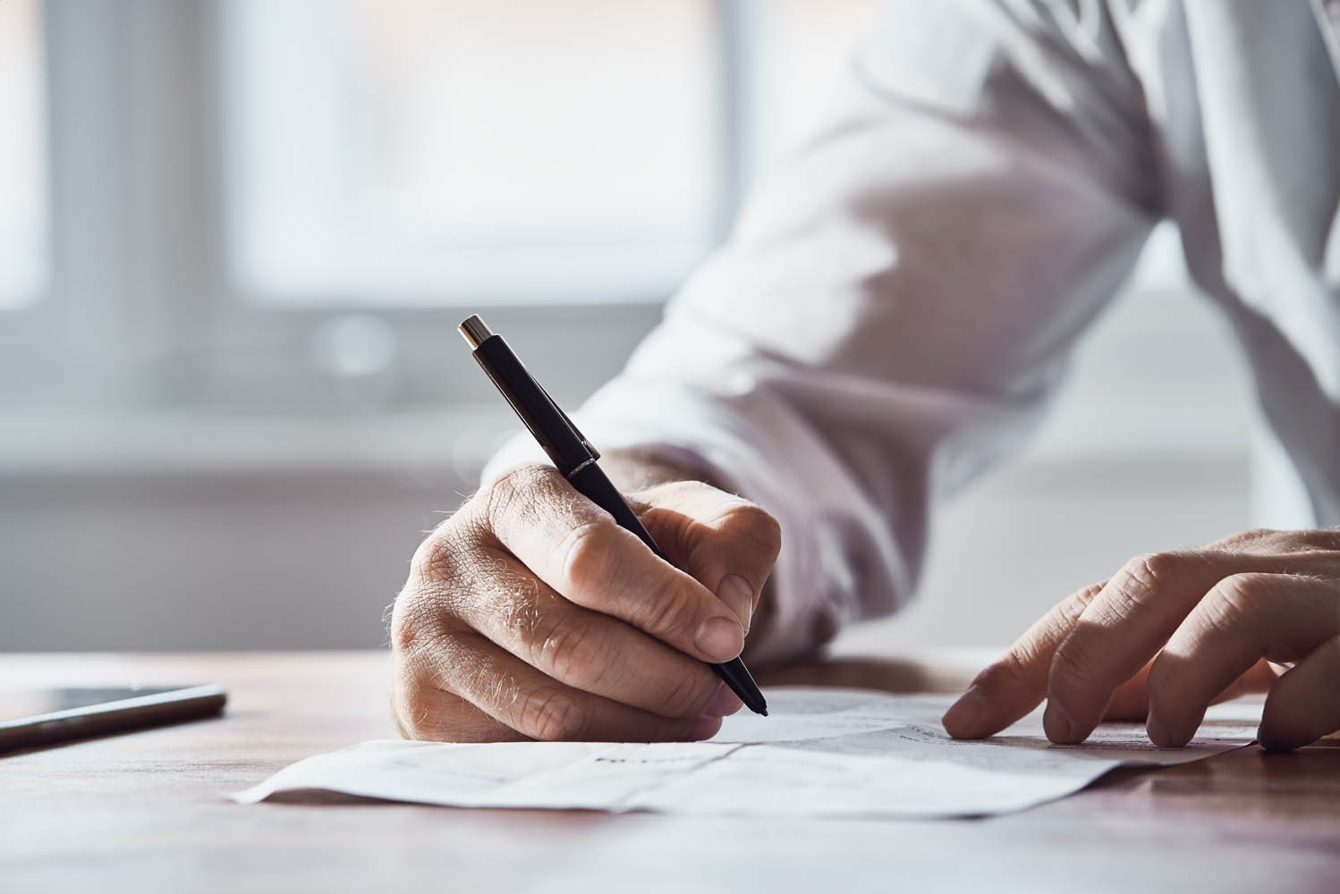 lawyer is signing papers with client